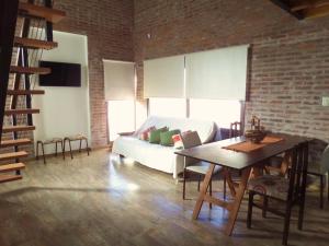 a living room with a couch and a table at Las Arecas in Carmen de Areco