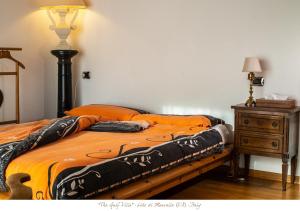 a bed in a bedroom with a lamp and a dresser at The Gulf Villa - Lago Maggiore in  Monvalle 