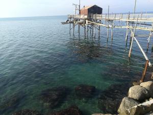 a dock in the water with a house on it at Io.te e il mare in Termoli