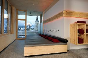 a room with a bench with a view of the city at Chasa Altana in Ischgl