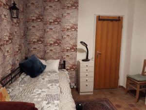 a bedroom with a bed and a lamp next to a door at One-bed room Mariensee in Neustadt am Rübenberge