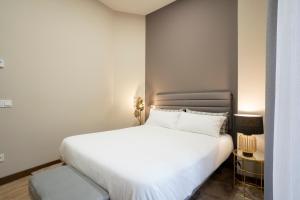 Кровать или кровати в номере DE LA GUARDIA SUITE 2