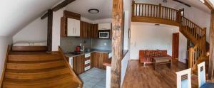 a kitchen and a living room with a spiral staircase at Penzion U Holuba in Hradčovice