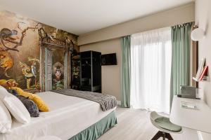 a bedroom with a bed with a painting on the wall at Anjoy&Bleev Rooms in Rho