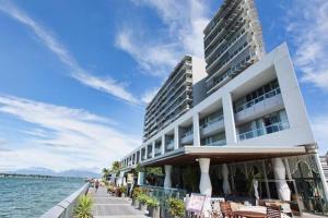 a hotel on the beach with the ocean in the background at 301 Harbour View in Cairns
