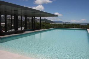 a large swimming pool in front of a building at 301 Harbour View in Cairns