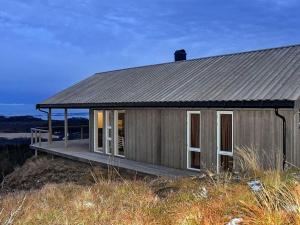 a small house on top of a hill at Holiday home Lyngstad in Lyngstad