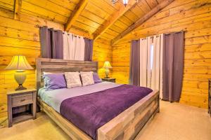 a bedroom with a bed in a log cabin at McCall Retreat with Hot Tub - half Mi to Downtown! in McCall
