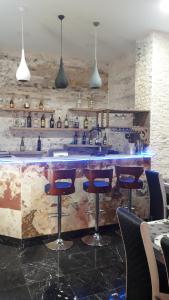 a bar with stools and a sink in a restaurant at 2 Room Deluxe Apartment in Bakuriani in Bakuriani