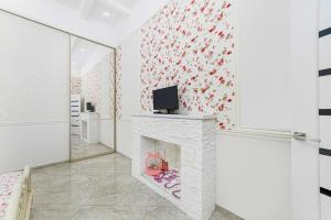 a living room with a fireplace with red flowers on the wall at NEW!Designer apartment on Deribasovskaya in Odesa