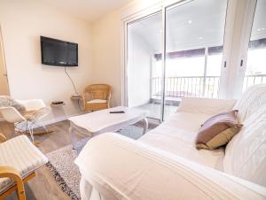 a bedroom with a bed and a tv on the wall at "Le Cocon" - 3 chambres et terrasse, centre-ville in Castelsarrasin