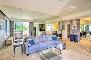 a living room with a blue couch and a table at Chic Palm Springs Retreat with View Near Escena Golf in Palm Springs