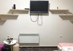 a room with a flat screen tv on a wall at Mps Lux Apartments in Niš