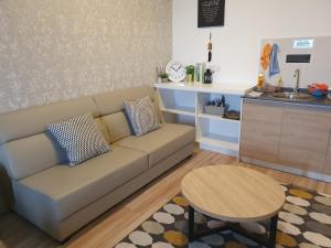 a living room with a couch and a table at MHB 30 SUlTE EVO SOHO BANDAR BARU BANGI FREE NETFLIX AND WIFI in Bangi
