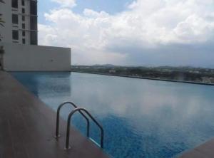 a swimming pool with a view of a building at MHB 30 SUlTE EVO SOHO BANDAR BARU BANGI FREE NETFLIX AND WIFI in Bangi