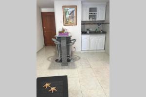 a kitchen with a table with a starfish on the floor at APARTAMENTO LAGUITO in Cartagena de Indias