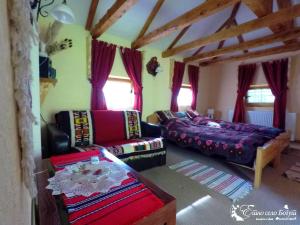 a living room with a couch and a bed at Ethno Village Bogut in Bogutovac