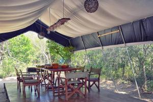 un tavolo e sedie posti sotto una tenda di Yala Leopard Mobile Camp a Yala