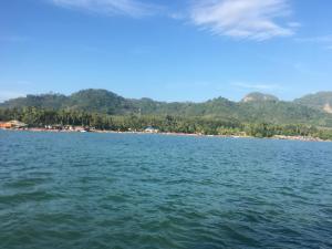 a large body of water with a beach in the background at Phumiphat resort Koh Mook in Trang