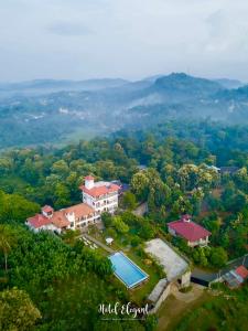 an aerial view of a house with a swimming pool at Elegant Hotel, Kandy in Kandy