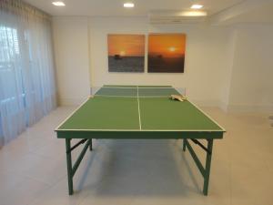 a ping pong table in the middle of a room at Fortaleza VIP Experience in Fortaleza