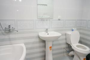 a bathroom with a toilet and a sink at B-House Hotel in Bukhara