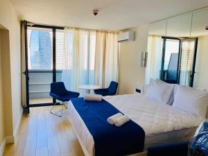 a hotel room with a bed and a table and chairs at Apartment Twin Towers David in Batumi