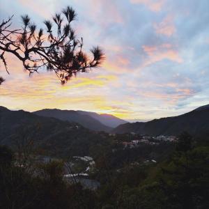 a view of the mountains with a sunset in the sky at Shan Ju Lake Villa in Renai