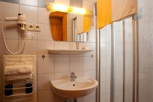 a bathroom with a sink and a mirror at Mörtbauerhof & Haus Frühauf in Seeboden