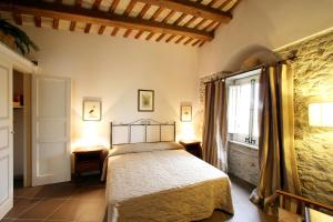 a bedroom with a bed and a window at Residence Erice Pietre Antiche in Erice