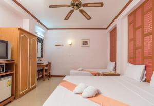 Un ou plusieurs lits dans un hébergement de l'établissement New Siam III Guest House