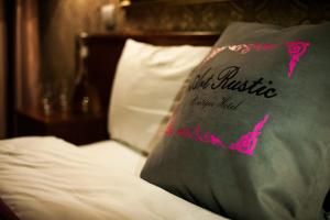 a pillow sitting on top of a bed at Art-Rustic Boutique Hotel in Chişinău