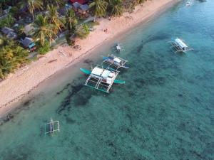 an overhead view of a beach with two boats in the water at Seafront Cottage Ocam Ocam Beach in Busuanga
