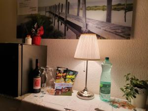 a table with a lamp and a bottle of water on it at DreamlandRanch Vorarlberg in Schlins