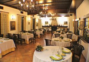 a restaurant with tables and chairs with white tablecloths at Casas Rurales VegaSierra in Bogarra