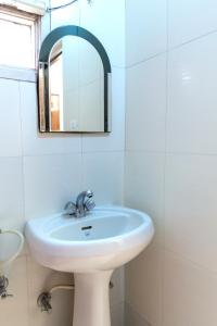 a bathroom with a sink and a mirror at Hotel Sakhi inn by Urban Galaxy in Amritsar