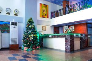 a christmas tree in the middle of a lobby at Hôtel Prince De Galles in Douala