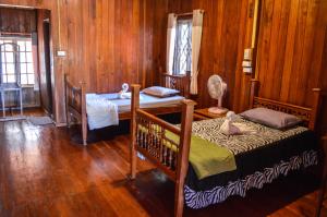 a bedroom with two bunk beds and a desk at Crossroads house in Mae Hong Son