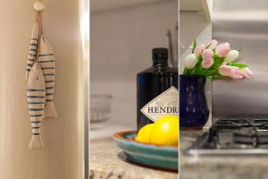 a kitchen counter with a bottle of wine and a vase of flowers at Number One - Nanjivey Row in St Ives