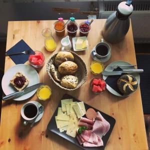 a wooden table with plates of food on it at Haus Hohensee in Clausthal-Zellerfeld