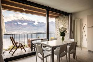 a dining room with a table and a view of a mountain at Il Giardino Di Lory in Vercana