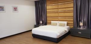 A bed or beds in a room at Zinnia Residences