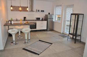 a kitchen with a counter and some stools in it at La Villa Vauban in Sélestat