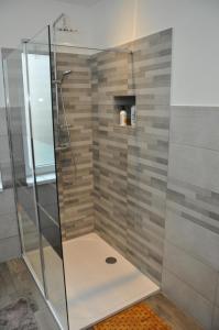 a shower stall with a glass door in a bathroom at Villa Vauban in Sélestat