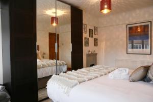 a bedroom with two beds and a large mirror at Lions Den - Zoo Accommodation Chester in Chester