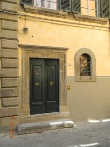 uma porta preta no lado de um edifício em Casa Ermenegilda em Cortona