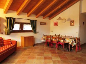 a dining room with a table and a couch at Baita al Pian in Bormio
