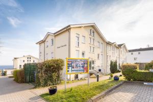 a large white building with a sign in front of it at Ferienwohnung Meeresbucht in Sassnitz