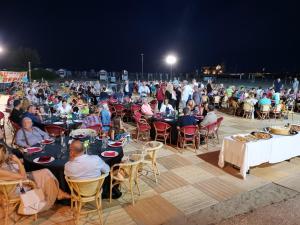 a large group of people sitting at tables at night at Hotel Sara in Caorle
