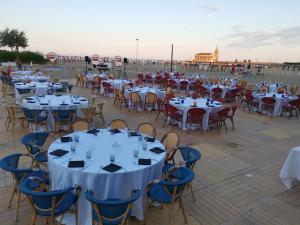 a group of tables and chairs on a deck at Hotel Sara in Caorle